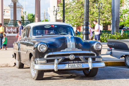 Cienfuegos, Cuba-October 13, 2016. Old, classic American, black Pontiac Chieftain 1953, four door sedan parcked next to the central square park on October 13, 2016 in historical  Cienfuegos town.のeditorial素材
