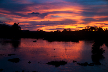 Peaceful Mekong river with great sunset views and boats flowing through Luang Prabangの写真素材