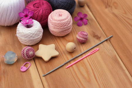 crochet pink and grey hooks and yarn, wooden background copy spaceの写真素材