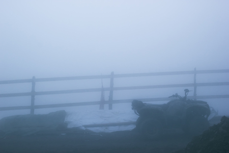 winter wooden fence iand quad bikeの写真素材