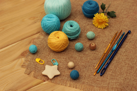 yellow and blue crochet yarn and hooksの写真素材