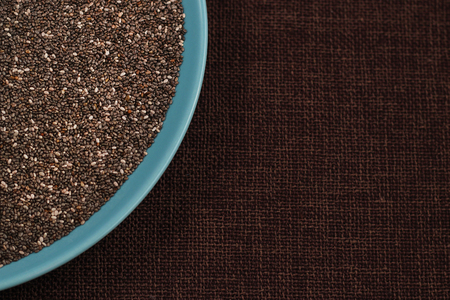 Healthy Chia seeds in a bowl on the table close-up. Text space.の写真素材