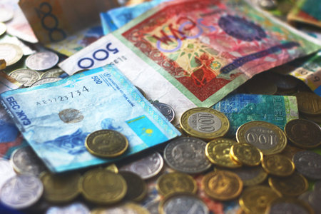Close up view on central asian kazakh and kyrgyz currencies banknotes and coins