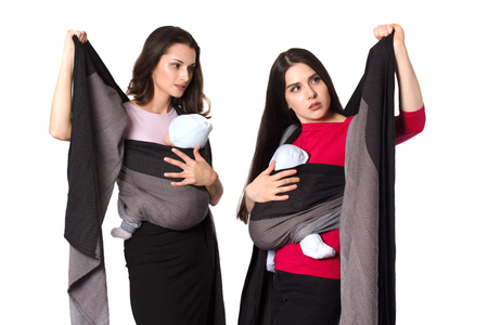 Babywearing instructor educate young mother how to use a woven wrap baby carrier and tight front wrap cross carryの写真素材