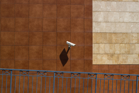CCTV camera installed in a mall wall for monitoring safety on a parkingの写真素材