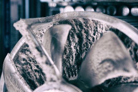 Old computer dirty cooler fan with dust inside. Burned computer parts conceptの写真素材