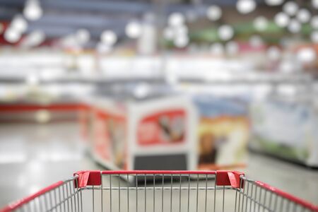 Blurred photo of store with trolley in department store bokeh backgroundの写真素材