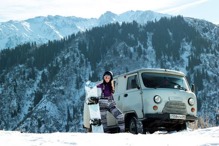 Almaty, Kazakhstan - January 10, 2019: UAZ 452 off road and snowboard burton girl in Tian-Shan mountain on freerideのeditorial素材