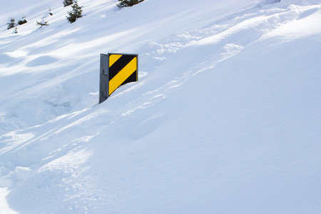 Country road sign after heavy snowfall on sunny day
