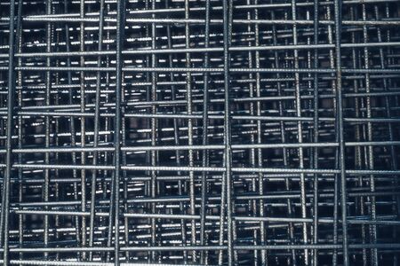 Steel bar for building materials. Wire reinforcing mesh. Industrial grunge background.の写真素材