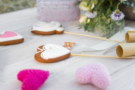 Close up view on heart shaped cookies bisquits on stick and wedding rings.の写真素材
