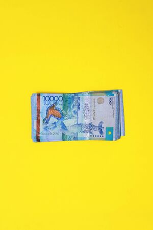 Kazakhstan 's currency on a yellow background. Ten thousand.の写真素材