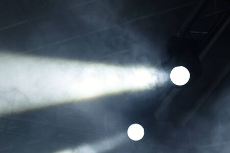 Ray of light with smoke and fog spotlights on the stage. Scene light equipmentの写真素材
