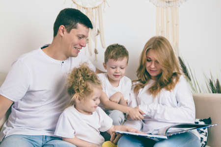Young parents reads with their children. Happy family conceptの写真素材