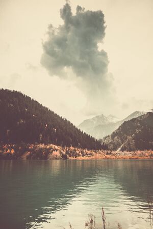 Landscape view of lake and mountain range before the rain in Tian Shan Mountains, Issyk city, Kazakhstanの写真素材
