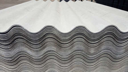 Asbestos roof. Asbestos-cement wave roofing sheets, corrugated panels, stacked on sale.の写真素材
