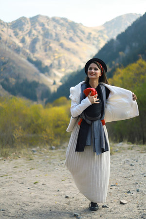 Beautiful young mother with her infant baby in sling outdoor. Woman is carrying her child and travel...