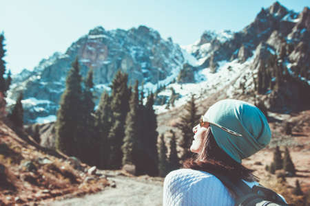 A woman in glasses looks into the blue sky. Outdoor recreation.の写真素材