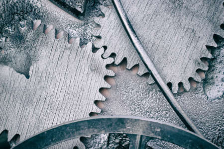 Silver gray grunge gears and wheels create an industrial steampunk backgroundの写真素材