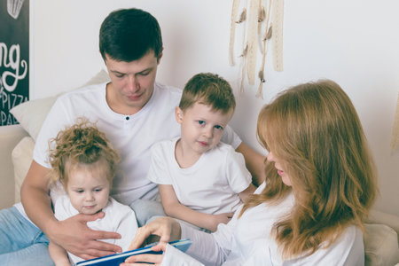Young parents reads with their children. Happy family concept.