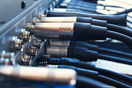 Close up audio jacks cable plugged into mixer console. XLR audio cable.