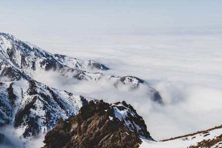 Tian Shan mountain peaks in the mist fog near Almaty city.