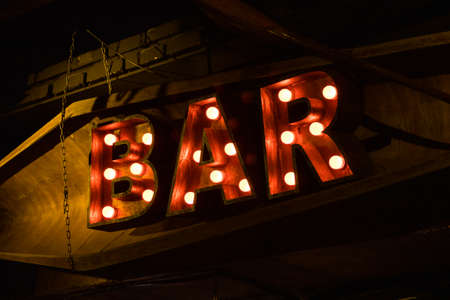 Big luminous red letters near the bar. Yellow lampsの写真素材