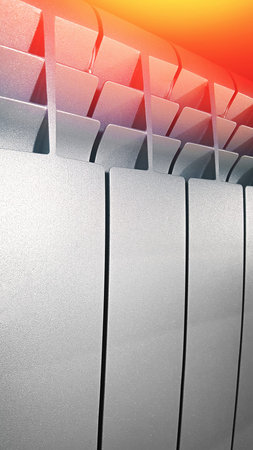 Close-up of aluminum white radiator in an apartment. Heating plumbing battery. Vertical, copy space,...