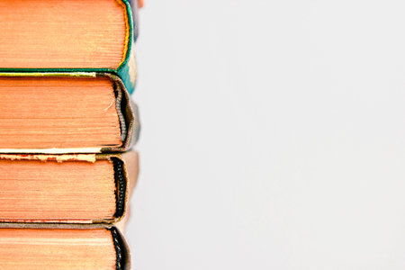 Close-up of stack of old used books background. Pile of vintage old hardback books. Back to school....