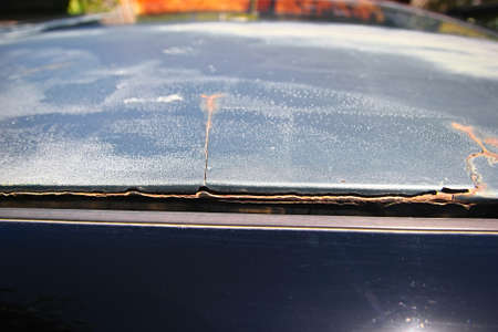 The consequences of poor-quality car body repair. The putty is peeling off the metal.の写真素材