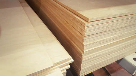 Stack of plywood sheets in the store. Wooden panel stacked. Lumber is sold at the supermarket in the warehouse.の写真素材