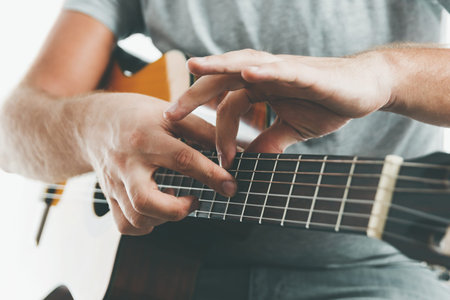Close-up on the hands of a guitarist playing classical guitar in two handed tapping technique