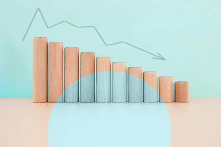 Wood block down graph with curve arrow, Risk management business financial and managing conceptの写真素材