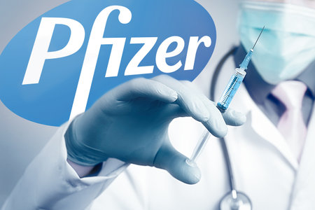 Pfizer Biontech vaccine against coronavirus COVID disease. Syringe in doctor hand and logo Pfizer on the backgroundのeditorial素材