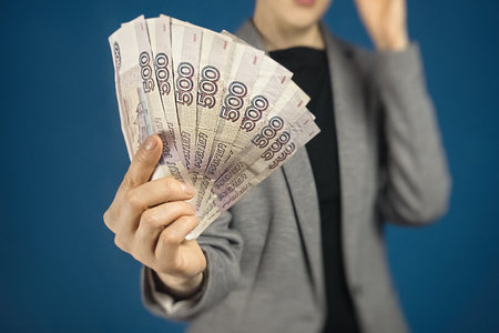 Woman holds Russian money in front of her. Close-up pack of ruble, Selective focusの写真素材