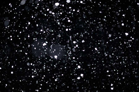 Real falling snow on black background for blending modes in ps. Ver 06 - many snowflakes in blur.の写真素材