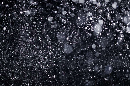 Real falling snow on black background for blending modes in ps. Ver 04 - many snowflakes in blur.の写真素材