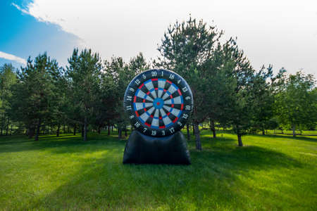 Large inflatable target outdoor. Giant darts in the yard. Summer leisure activity concept, copy space.の写真素材