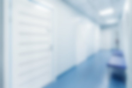 Blurred empty corridor in modern hospital for background.