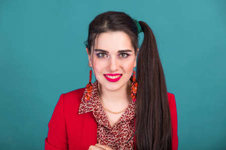 Bright colorful makeup in the style of 80s and 90s on a beautiful young woman.の写真素材