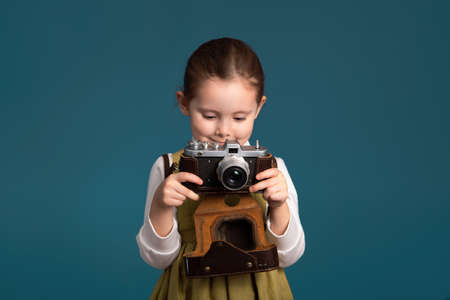 Cute little girl happy with photography learning results.の写真素材