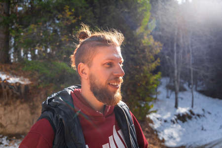 Outdoor portrait of blond bearded smiling hipster man in nature.の写真素材