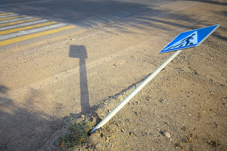 Accident at a pedestrian crossing. Downed pedestrian crossing road sign CIS.の写真素材