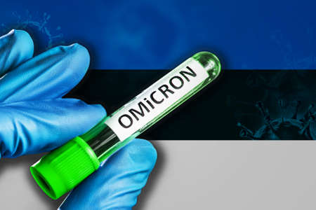 Estonia outbreak of omicron variant. A hand in a blue rubber glove holds a test tube with covid-19 virus omicron in front of Estonia flag. Omicron variant outbreak conceptの写真素材