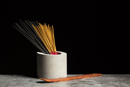 Many different aromatic incense sticks and wooden stands for them. copyspace.