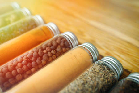 Spices and herbs of different colors in small jars. corner view.の写真素材