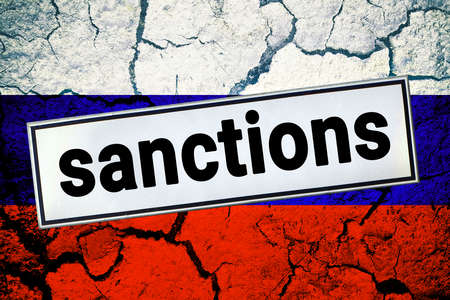 Sanction sign on a cracked Russian flag. Sanctions economic and geopolitical restrictions on Russia due to the military conflict concept.の写真素材