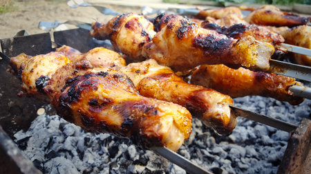 Close-up of grilled chicken meat, fried chicken meat on skewers on the grill.の写真素材