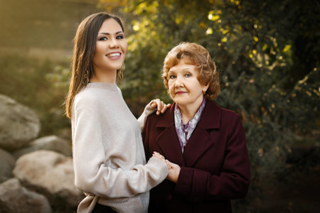 Happy mom with daughter holding hands outdoors in the forest. High quality photoの写真素材
