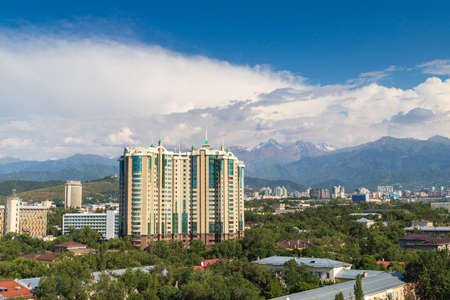 Modern multi-storey residential complex CAPITAL CENTER among the old buildings of the Medeu district of Almaty. Almaty, Kazakhstan - July 02, 2021のeditorial素材